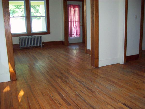 380 Nottingham Street Springfield, MA 01104 - Photo 5 of 18 a view of an empty room with wooden floor and a window