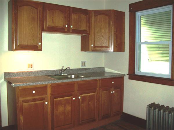 380 Nottingham Street Springfield, MA 01104 - Photo 7 of 18 a room with wooden cabinets and a sink