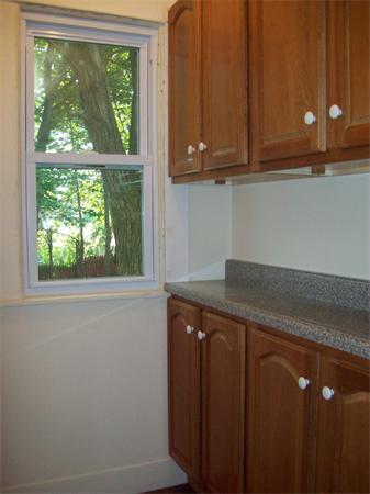 380 Nottingham Street Springfield, MA 01104 - Photo 9 of 18 a kitchen with a sink a window and cabinets