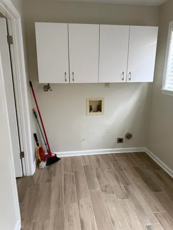 a view of a room with wooden floor