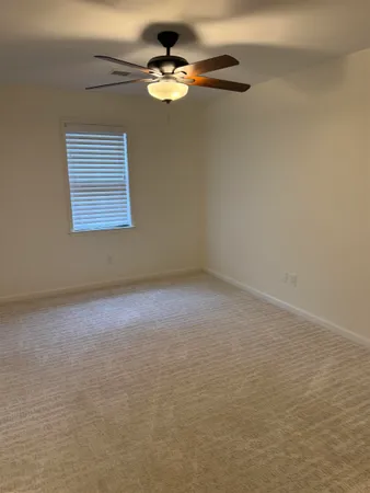 a view of room with a ceiling fan