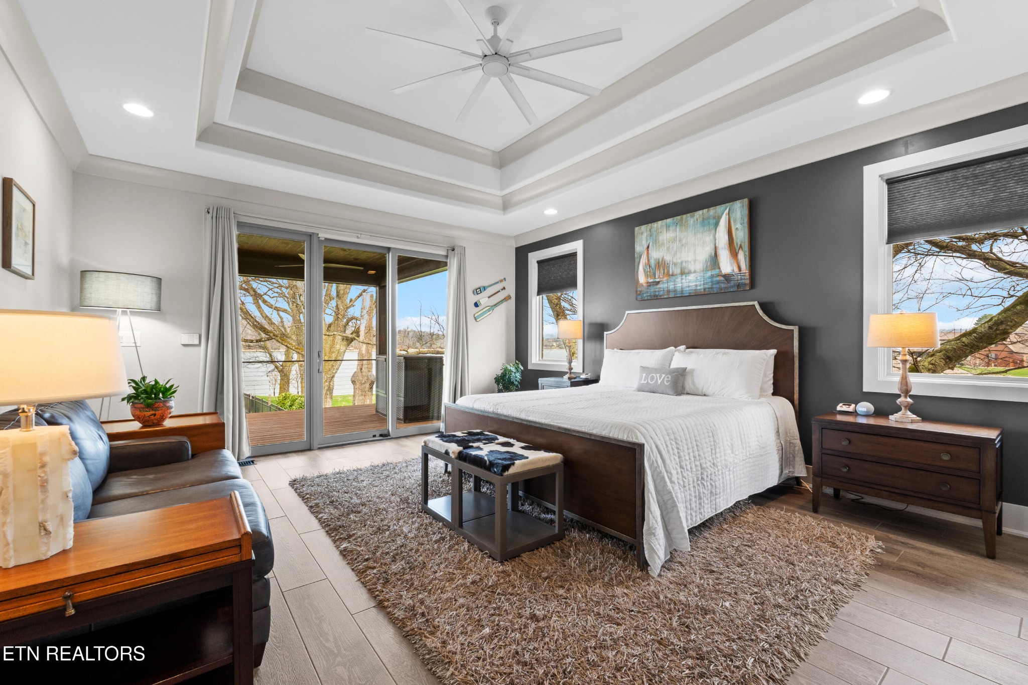3702 Promontory Point Louisville, TN 37777 - Photo 17 of 60 a bedroom with a bed a couch and large window