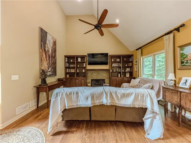 a spacious bedroom with a bed and a table in it
