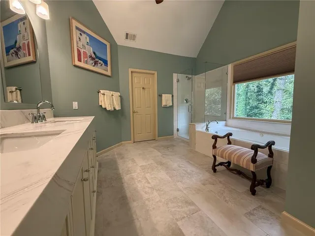 a bedroom with a bed and a ceiling fan