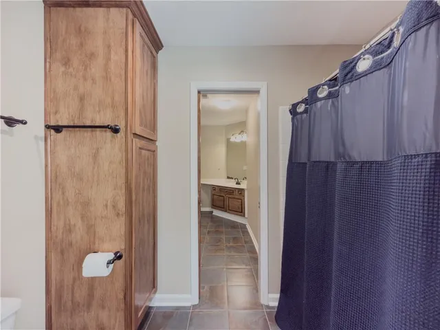 a bedroom with a bed and ceiling fan