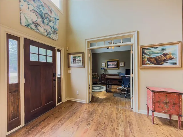a view of a workspace with furniture and a flat screen tv