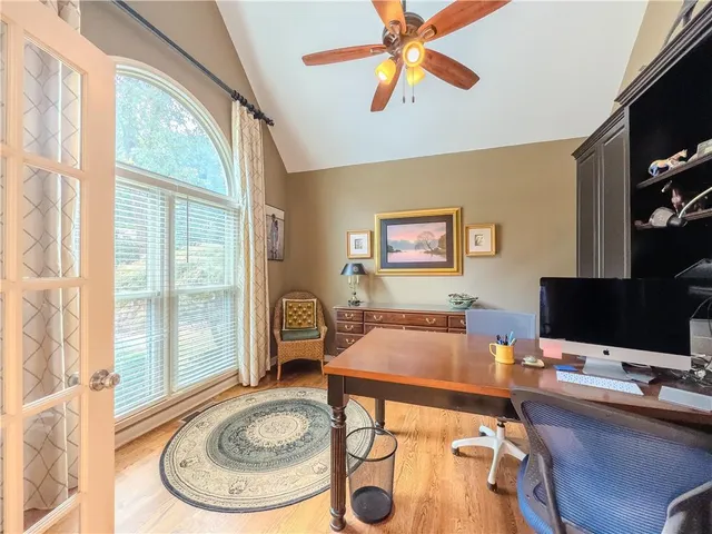 a view of a dining room with furniture wooden floor and chandelier