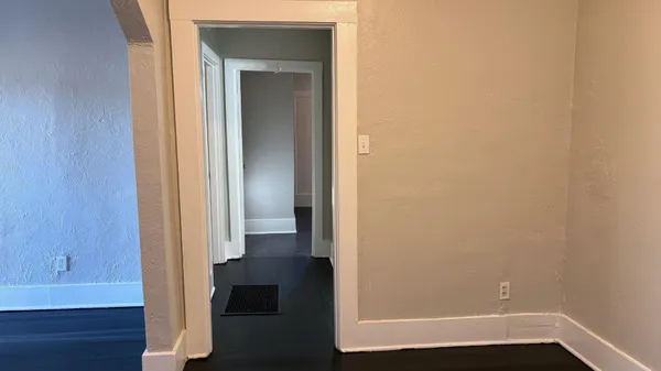 a view of hallway with wooden floor