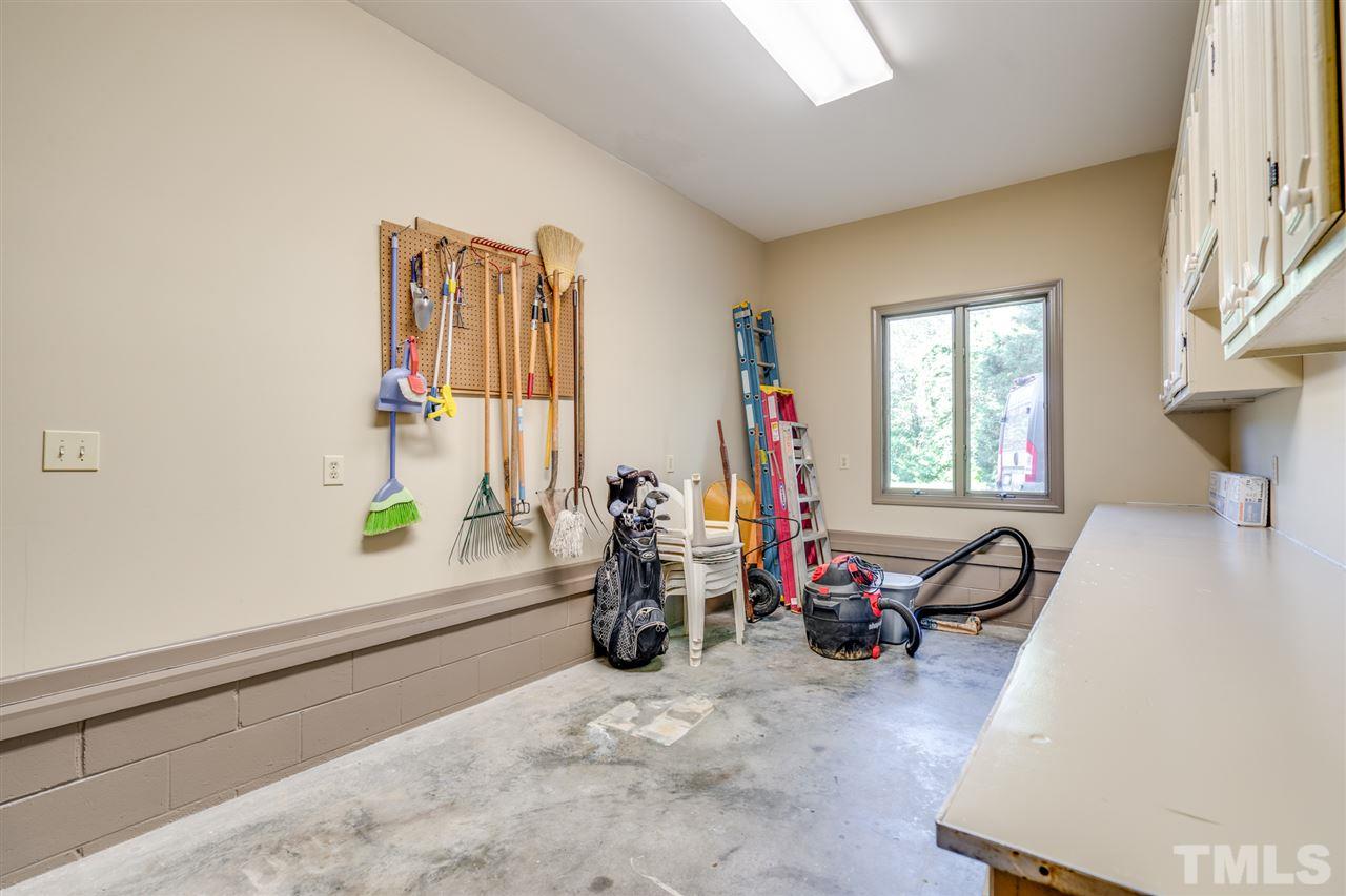 330 Red Oak Road Henderson, NC 27537 - Photo 22 of 29 Door from the garage to the spacious storage room with an outside door to the back yard