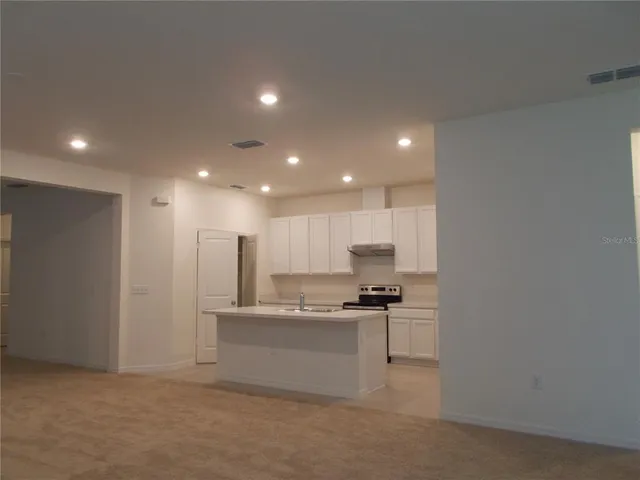 a kitchen with stainless steel appliances granite countertop a refrigerator sink and cabinets
