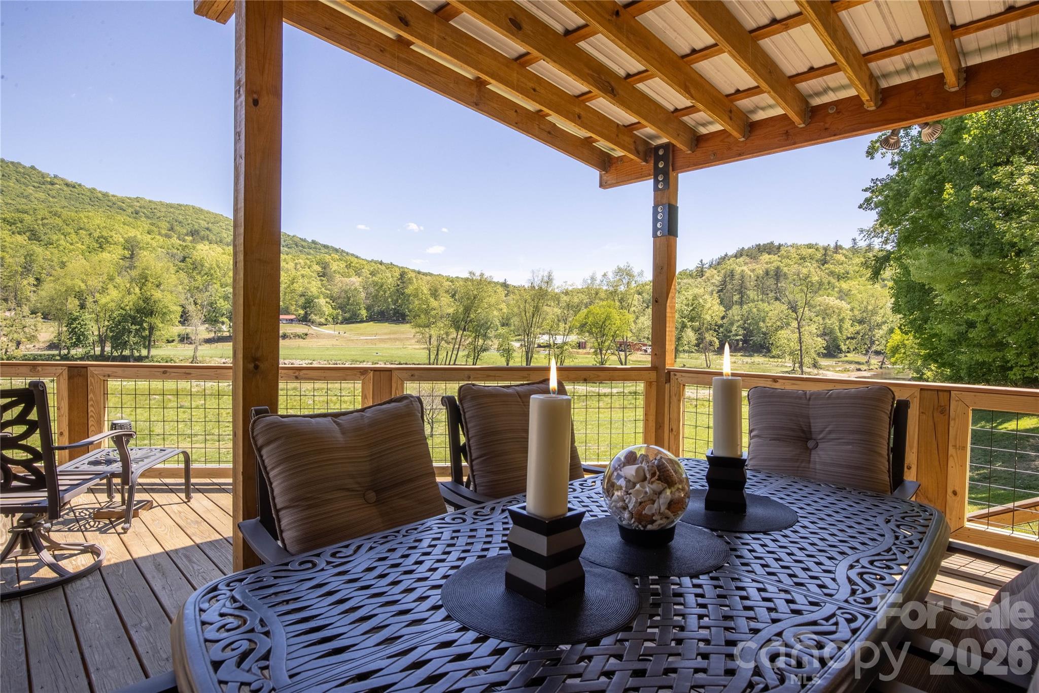 93 Franklin Crest Road Spruce Pine, NC 28777 - Photo 24 of 47 a view of a balcony with floor to ceiling windows with wooden floor