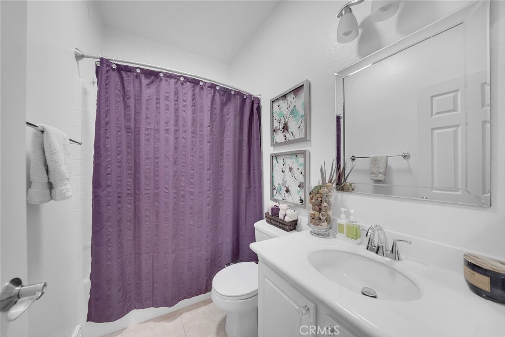 23 Carnation Irvine, CA 92618 - Photo 11 of 30 a bathroom with a sink a toilet and shower curtain