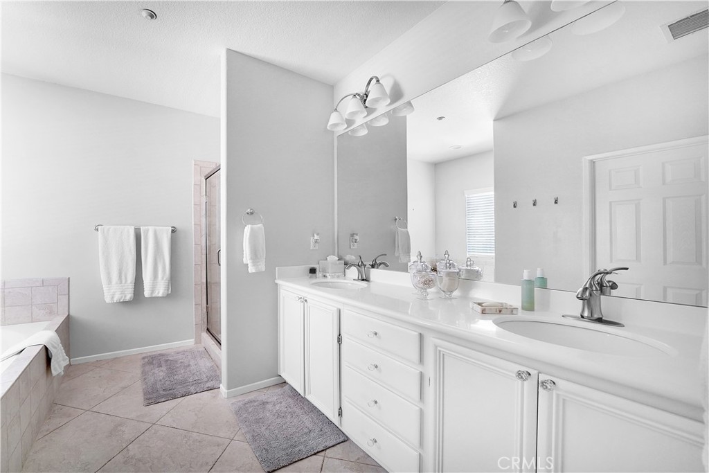 23 Carnation Irvine, CA 92618 - Photo 17 of 30 a bathroom with a double vanity sink mirror and