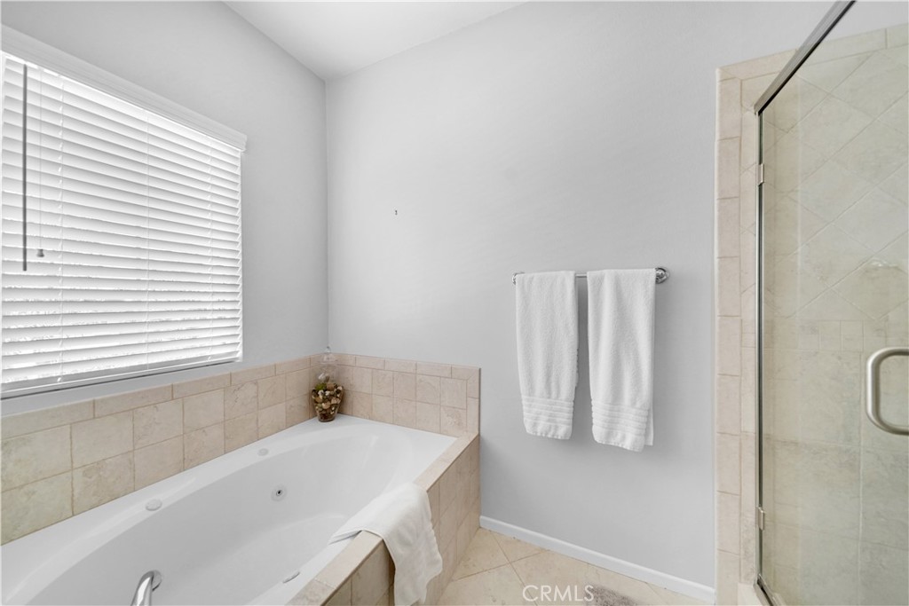 23 Carnation Irvine, CA 92618 - Photo 18 of 30 a bathroom with a tub sink and a window