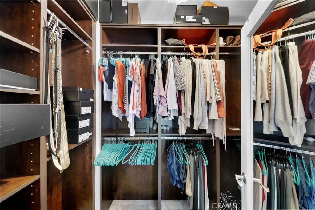 23 Carnation Irvine, CA 92618 - Photo 19 of 30 a view of walk in closet with clothes and shoes