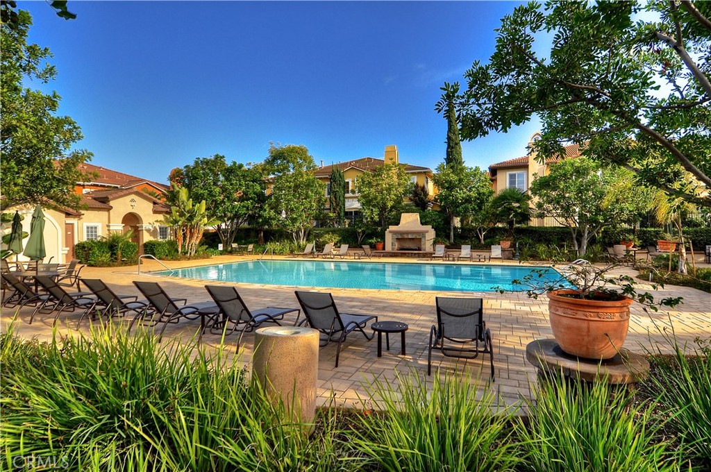 23 Carnation Irvine, CA 92618 - Photo 23 of 30 a view of a patio with table and chairs potted plants and palm tree