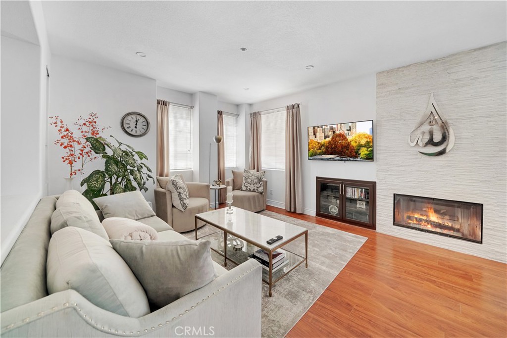 23 Carnation Irvine, CA 92618 - Photo 3 of 30 a living room with furniture and a fireplace