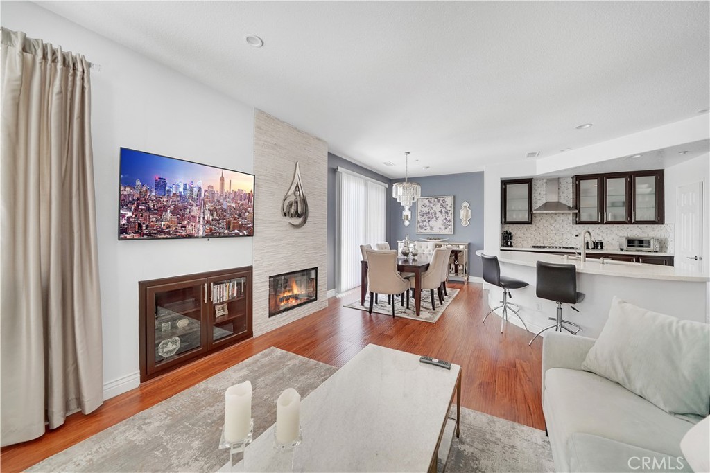 23 Carnation Irvine, CA 92618 - Photo 7 of 30 a living room with furniture a fireplace and a flat screen tv