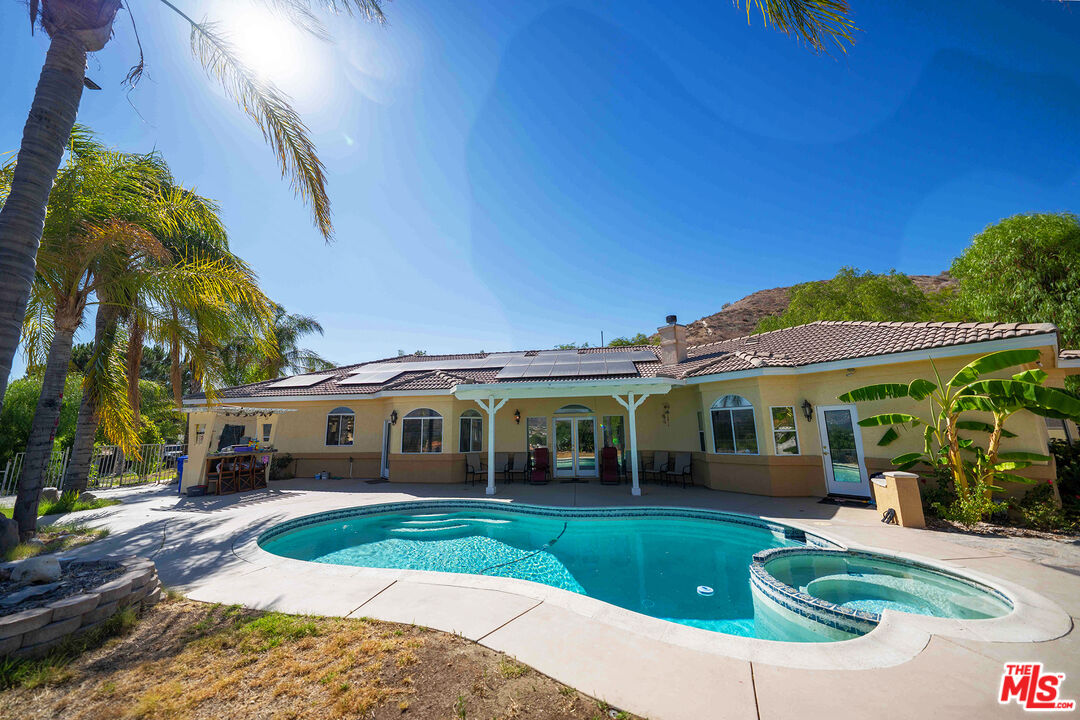a front view of a house with a yard table and chairs