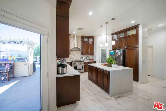 a kitchen with stainless steel appliances a sink stove and refrigerator
