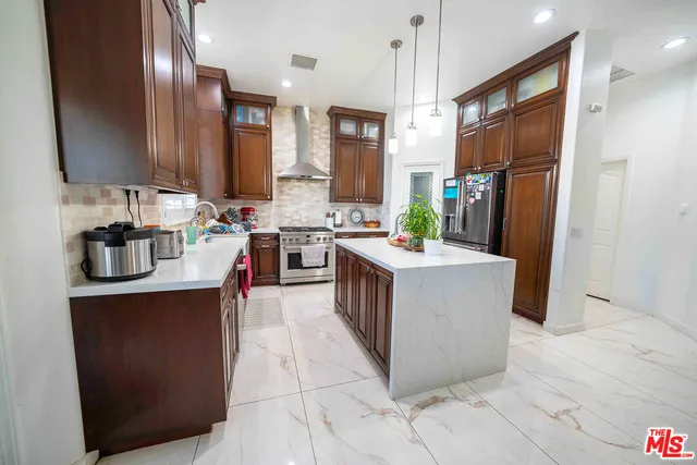 a kitchen with granite countertop a stove top oven microwave and cabinets