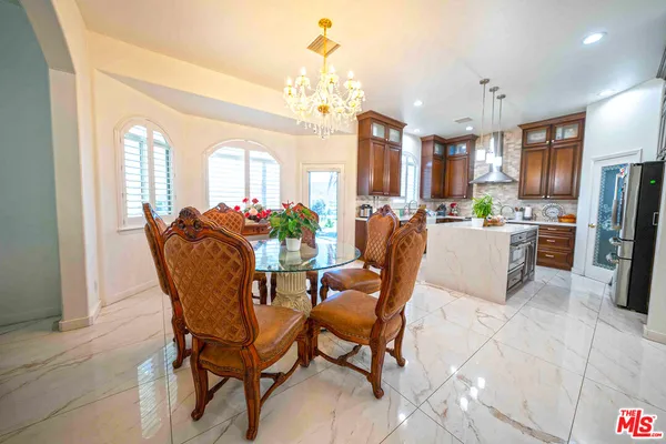 a view of a kitchen with kitchen island a sink a counter top space and living room view