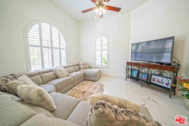 a bedroom with furniture and a flat screen tv