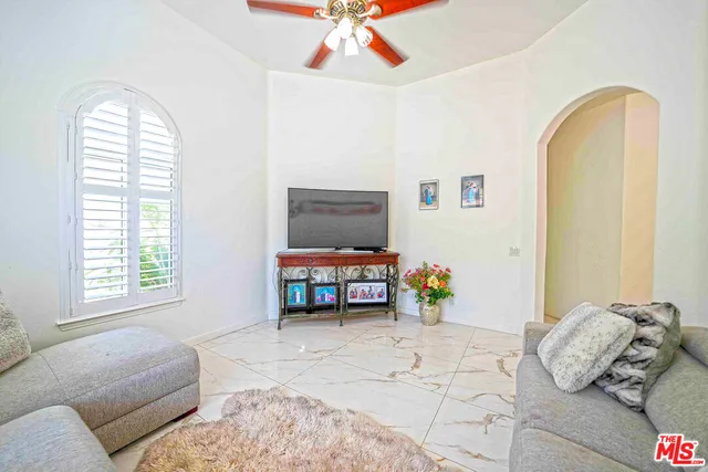 a view of a workspace with furniture and a window