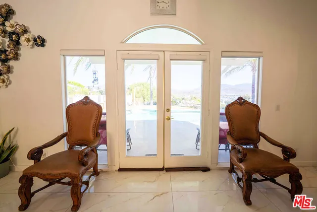 a view of a livingroom with furniture mirror and wooden floor
