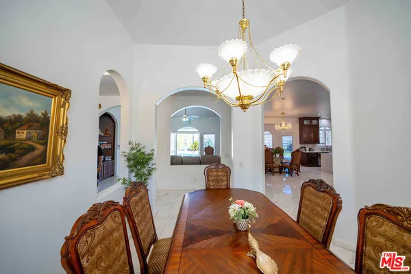 a living room with furniture a fireplace and a chandelier
