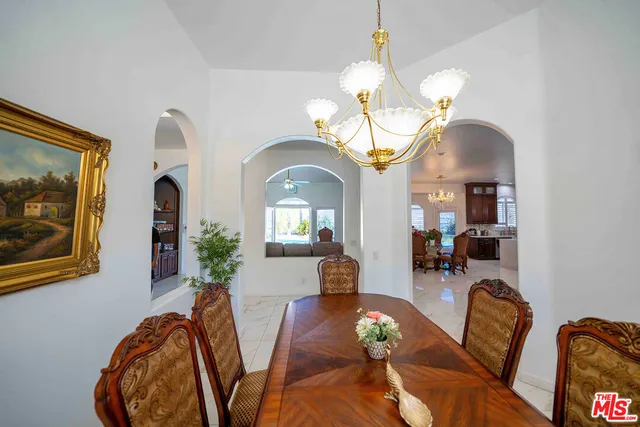 a living room with furniture a fireplace and a chandelier