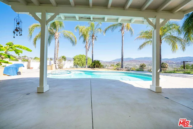 a view of a swimming pool with a yard