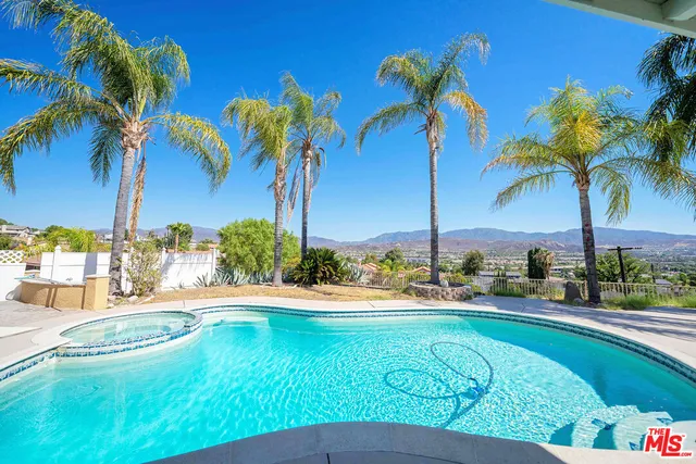 a view of swimming pool with a table and chairs