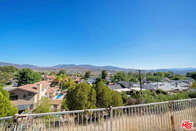 a view of backyard with swimming pool and furniture