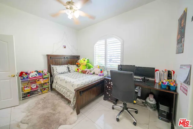 a bedroom with a workspace