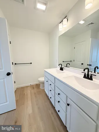 a bathroom with a double vanity sink and mirror