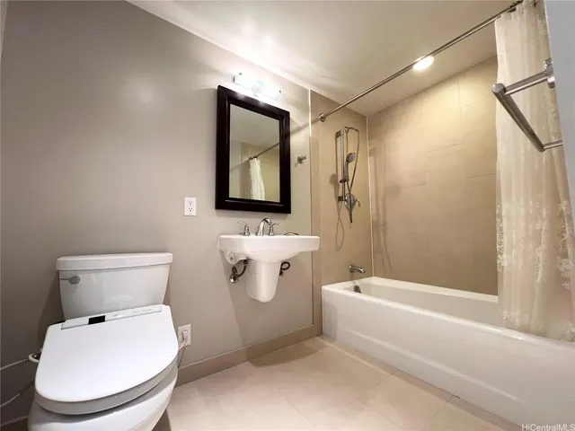 a bathroom with a toilet a sink and bathtub