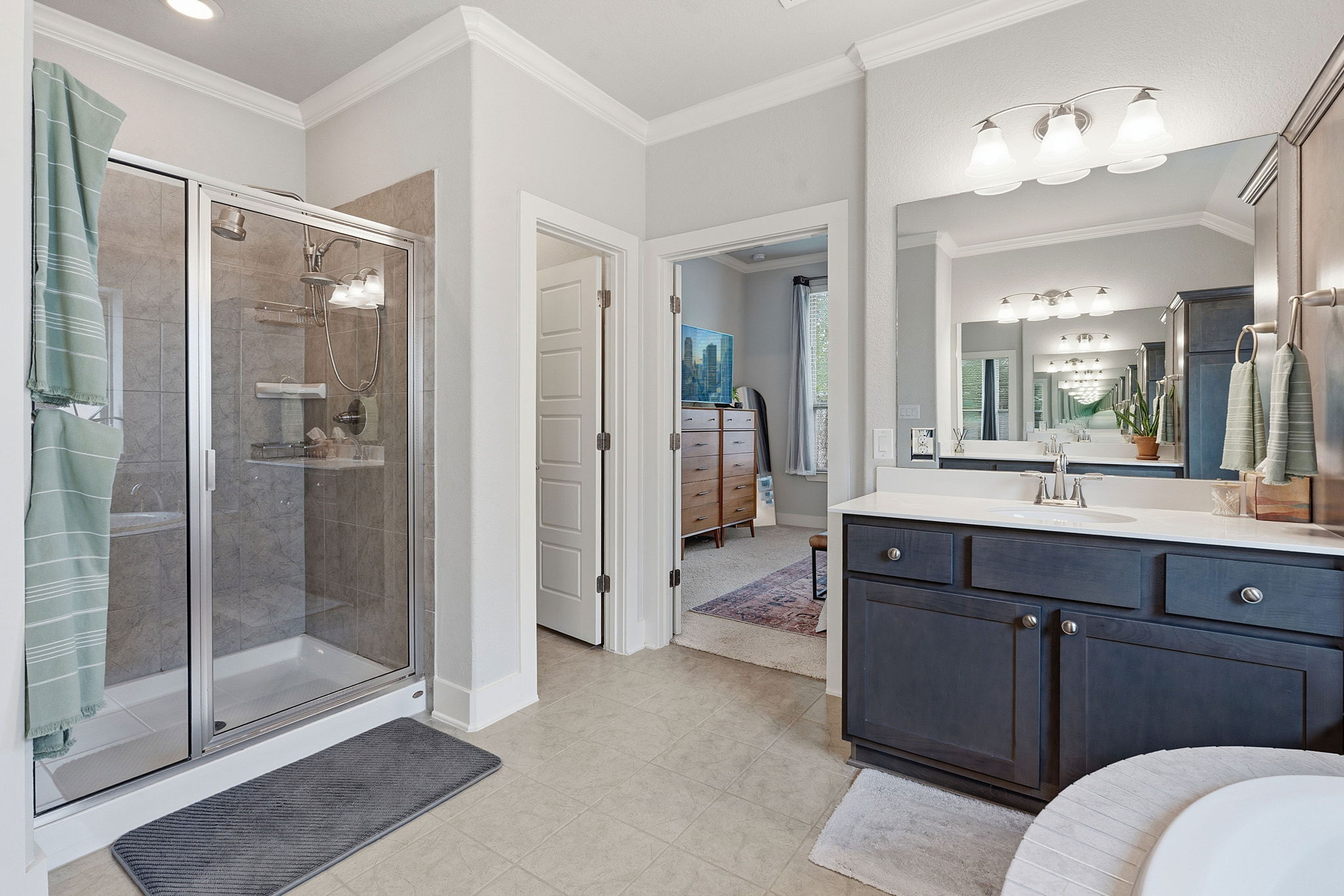 104 Red Granite Road Georgetown, TX 78633 - Photo 20 of 36 a spacious bathroom with a shower sink and mirror