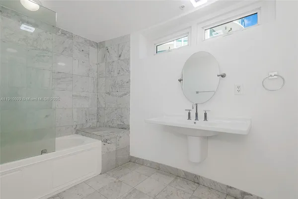 a bathroom with a sink a toilet and bathtub