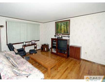 160 Stratton Street South Piscataway, NJ 08854 - Photo 2 of 8 a living room with furniture a window and a flat screen tv
