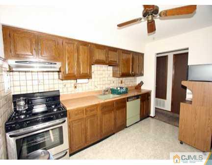 160 Stratton Street South Piscataway, NJ 08854 - Photo 4 of 8 a kitchen with a stove and a microwave
