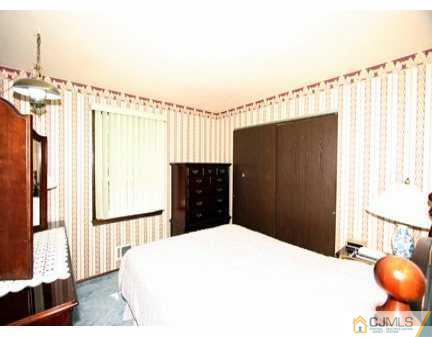 160 Stratton Street South Piscataway, NJ 08854 - Photo 6 of 8 a bedroom with a bed and a window