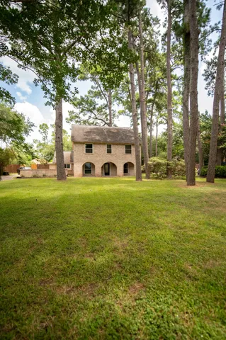a view of a big yard with large trees
