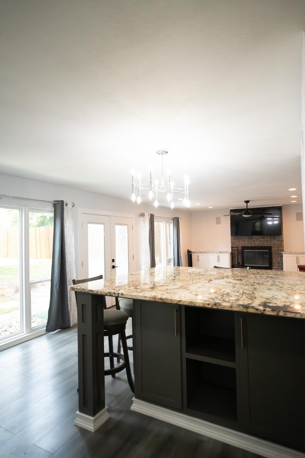 17106 Spring Creek Forest Drive Spring, TX 77379 - Photo 15 of 50 a kitchen with kitchen island granite countertop a sink cabinets and wooden floor