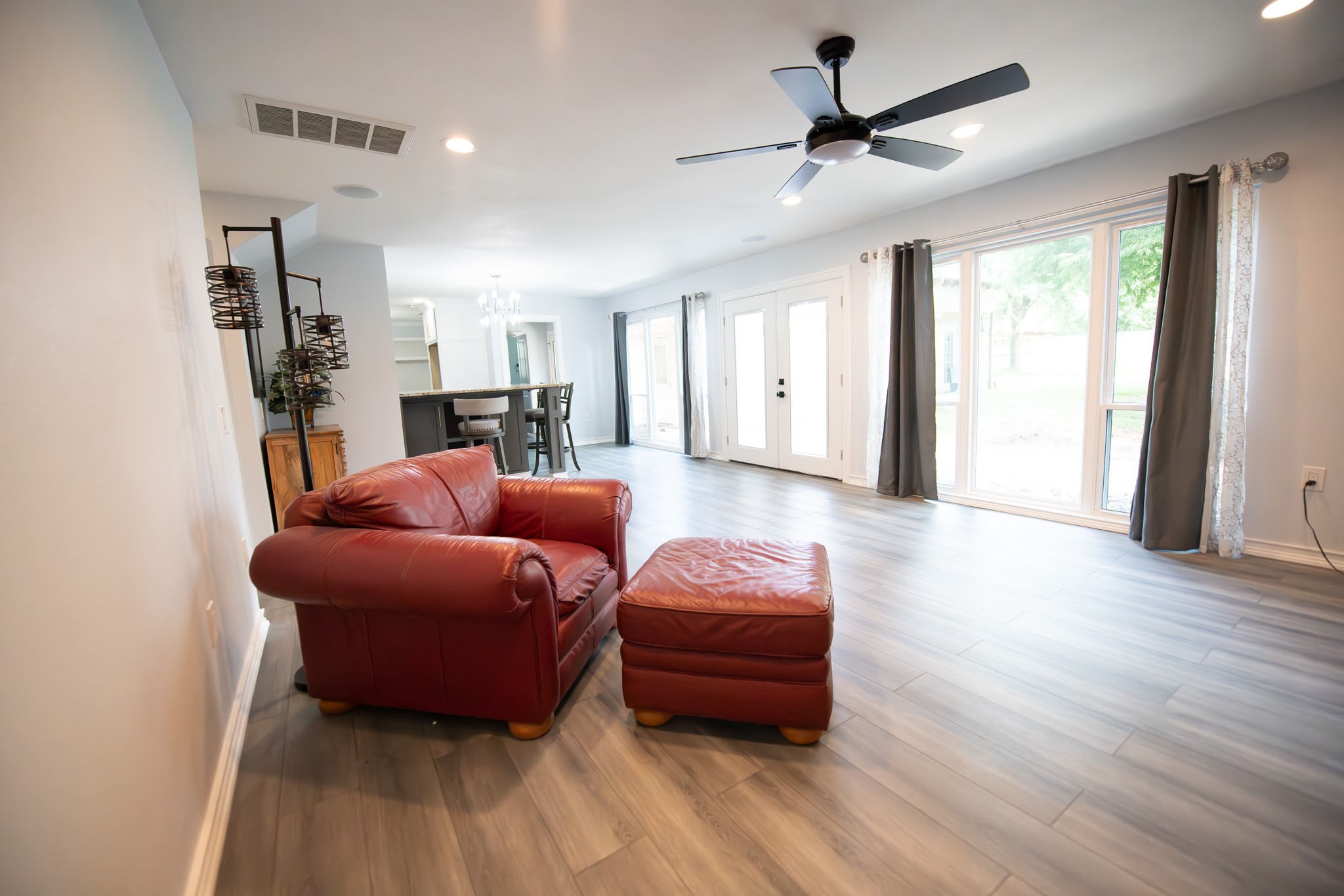 17106 Spring Creek Forest Drive Spring, TX 77379 - Photo 21 of 50 a living room with furniture a ceiling fan and a rug
