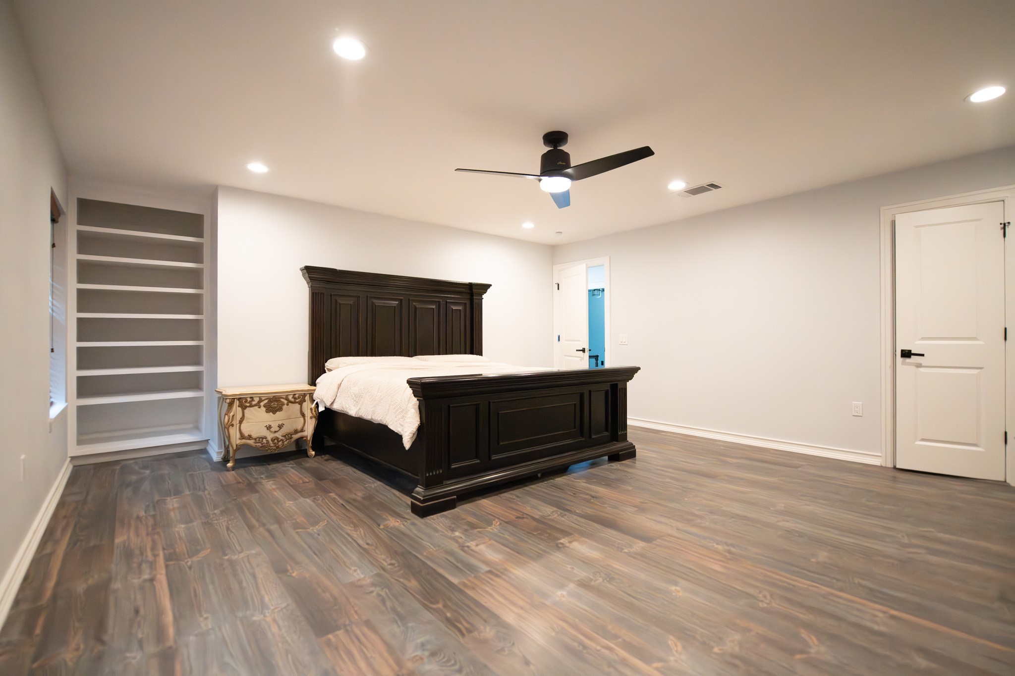 17106 Spring Creek Forest Drive Spring, TX 77379 - Photo 27 of 50 a bedroom with a bed and a chandelier
