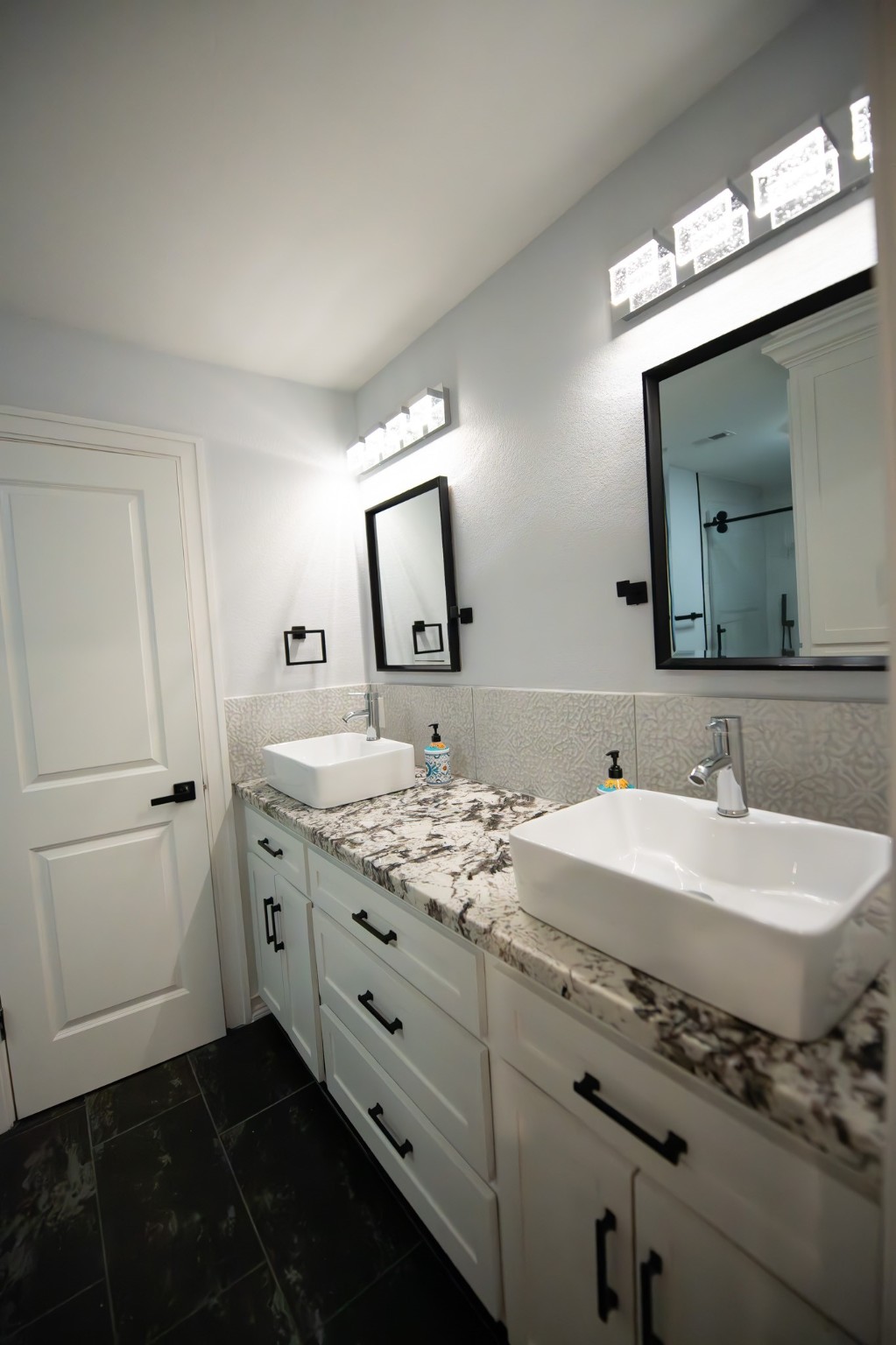 17106 Spring Creek Forest Drive Spring, TX 77379 - Photo 29 of 50 a bathroom with a double vanity sink and a mirror