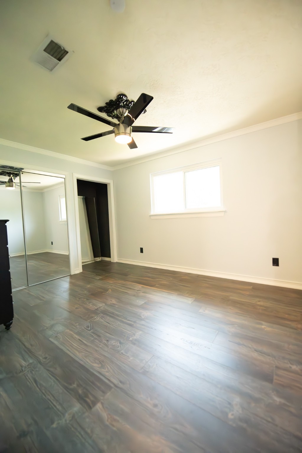 17106 Spring Creek Forest Drive Spring, TX 77379 - Photo 35 of 50 an empty room with wooden floor and windows