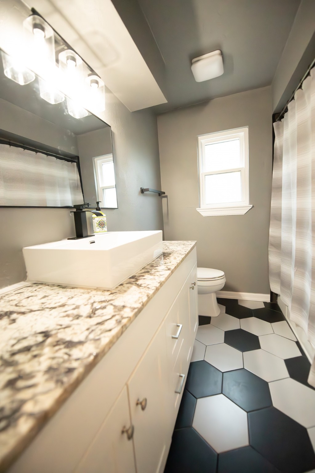 17106 Spring Creek Forest Drive Spring, TX 77379 - Photo 41 of 50 a bathroom with a sink a toilet and a mirror