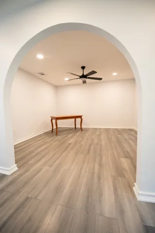 a view of a room with wooden floor